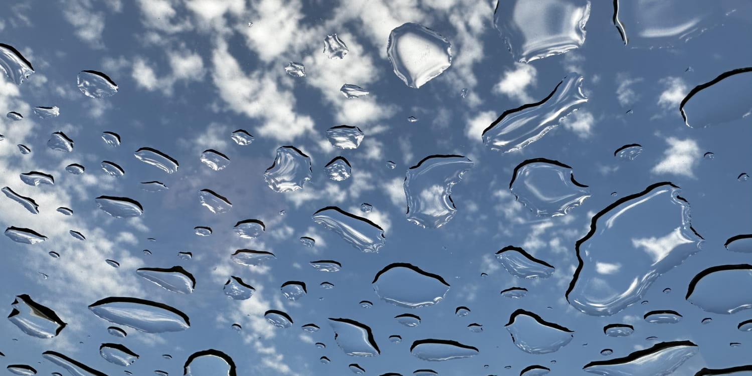 Droplets of water on glass under the clouds.