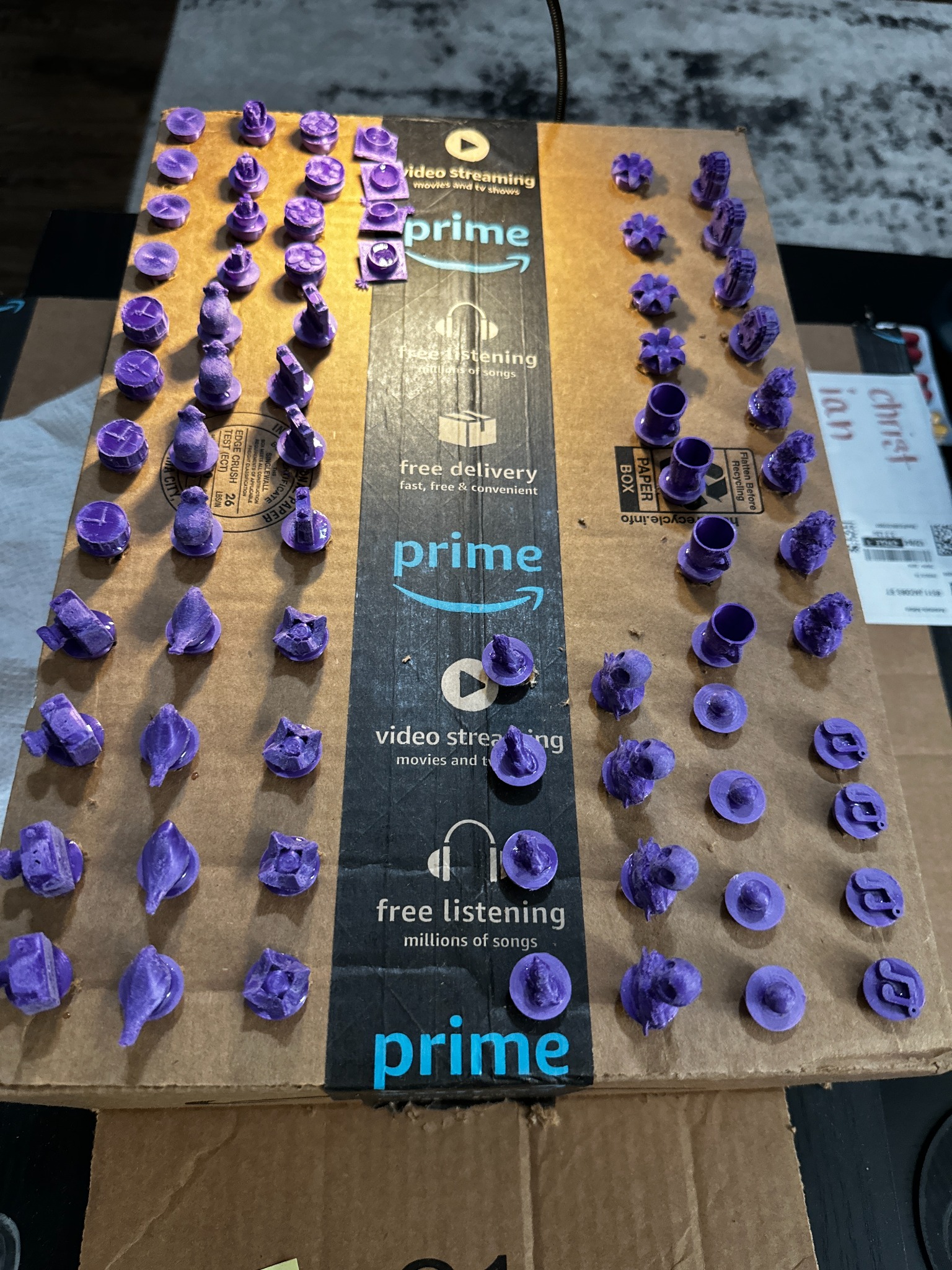 72 raw printed marbles organized in rows on cardboard, fresh off the printer