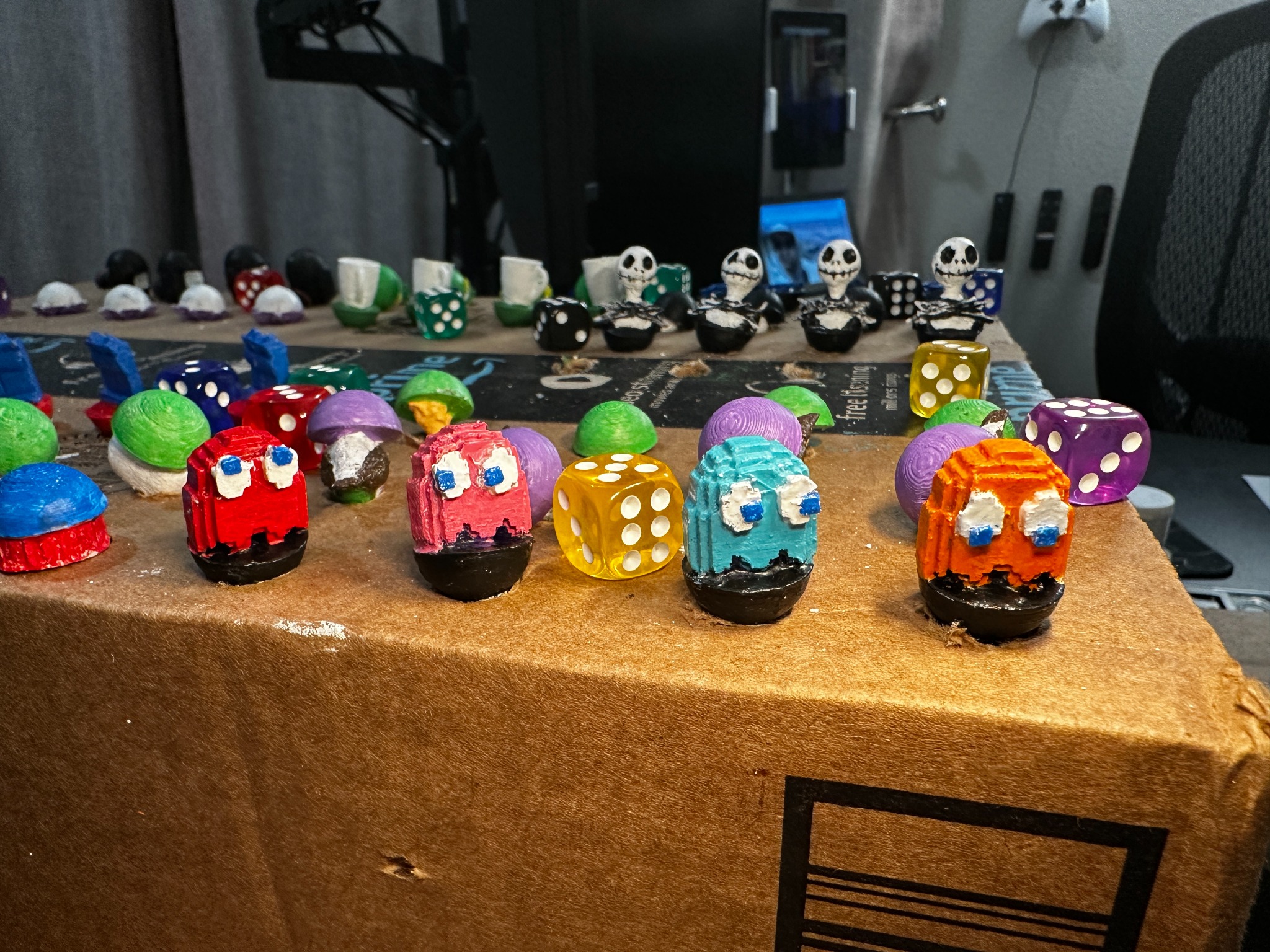 Close-up of ghost set with hand-painted faces in red, pink, teal, and orange