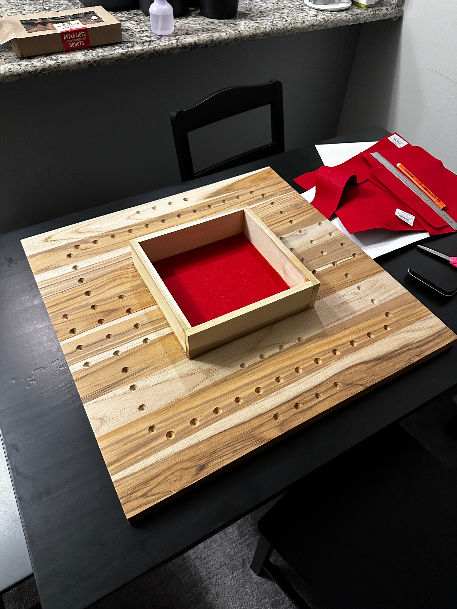 Finished wooden marble board with red felt dice tray in center
