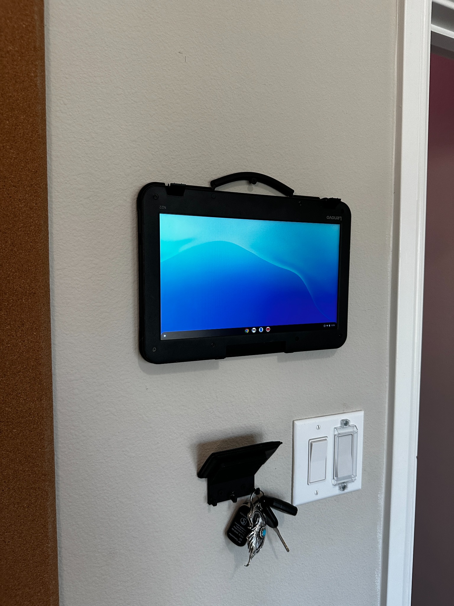 Chromebook mounted vertically on wall as a digital display screen