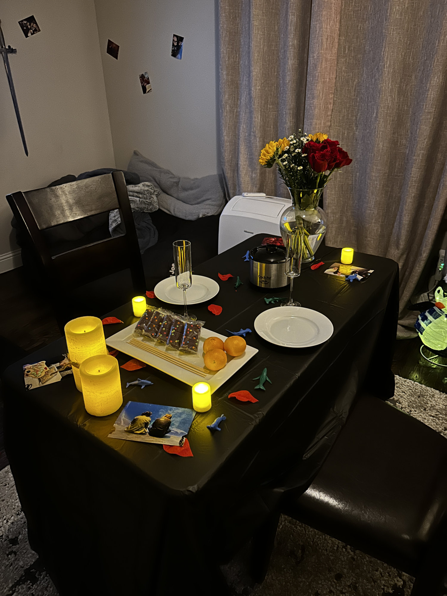 A table with flowers, glasses, and chocolate fondue